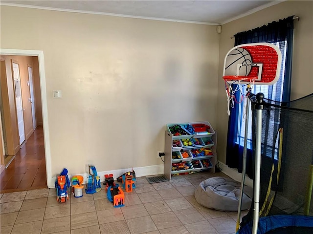 playroom with light tile patterned flooring and ornamental molding