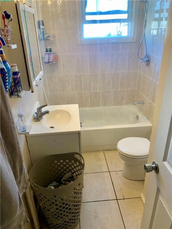 full bathroom featuring vanity, tiled shower / bath combo, tile patterned floors, and toilet