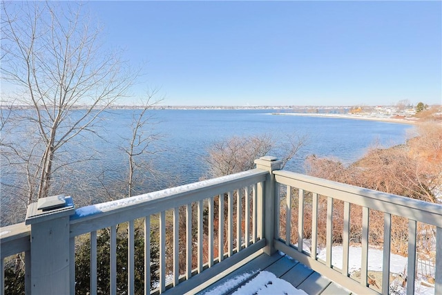 wooden terrace featuring a water view