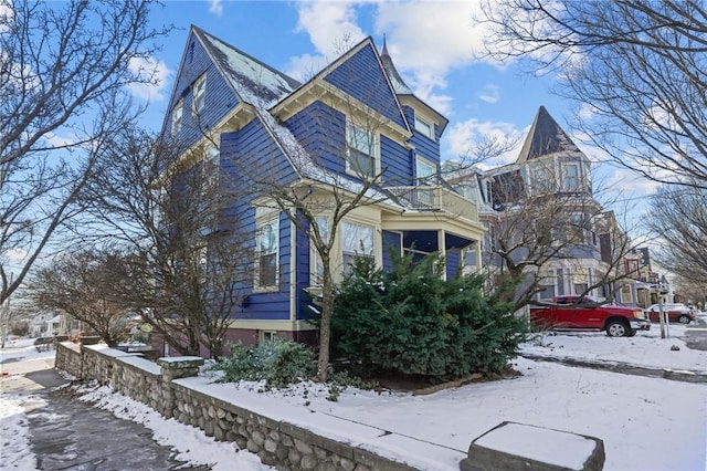 view of snowy exterior with a balcony