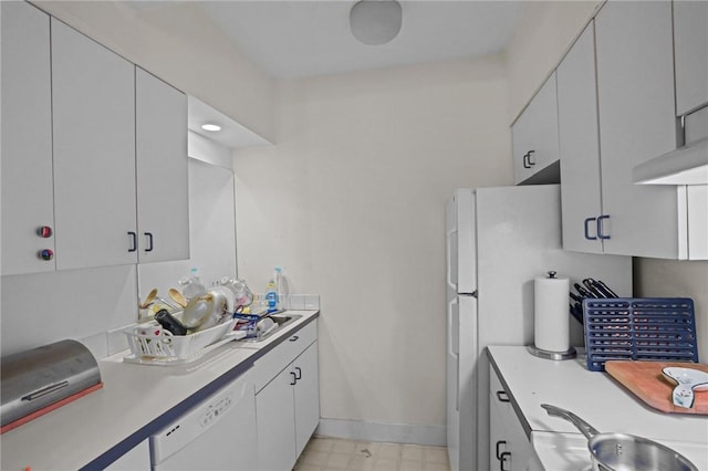 kitchen with white dishwasher, sink, and white cabinetry