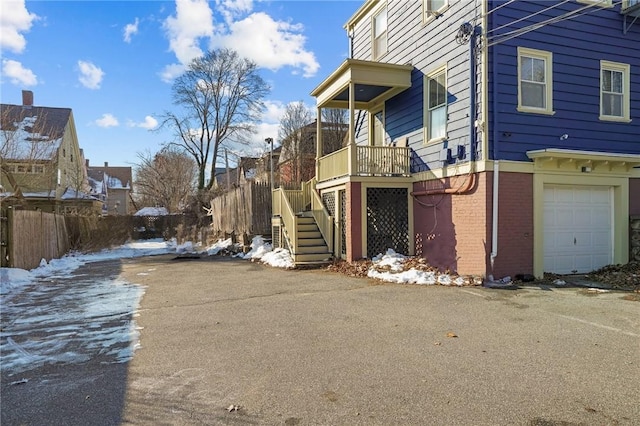 view of snow covered exterior featuring a garage