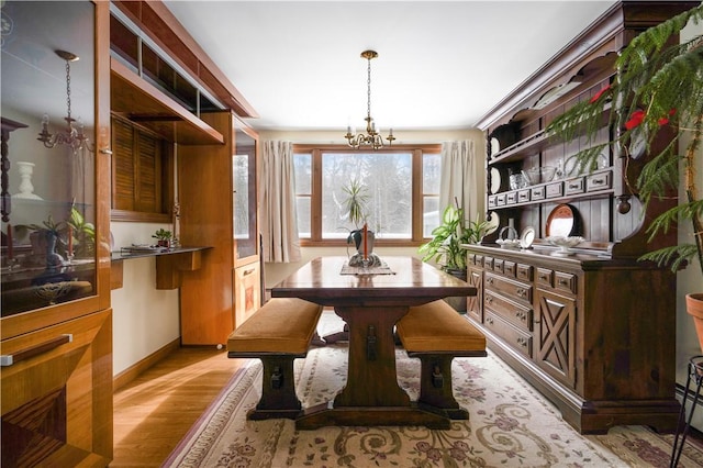 dining space with a chandelier and light hardwood / wood-style flooring