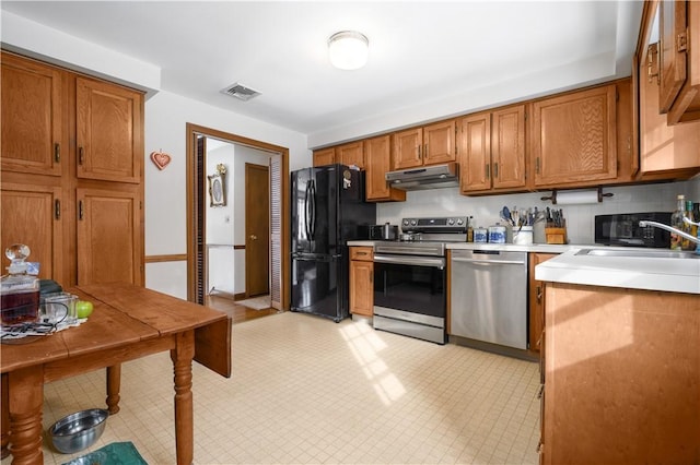 kitchen featuring sink, decorative backsplash, and appliances with stainless steel finishes