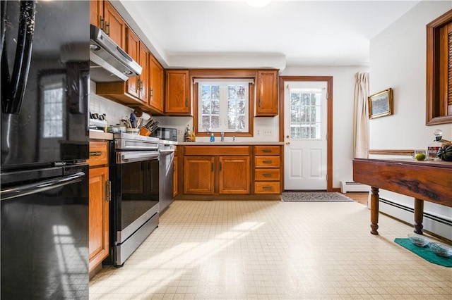 kitchen featuring a baseboard radiator, stainless steel appliances, and sink