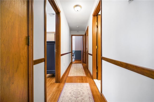 corridor with light wood-type flooring