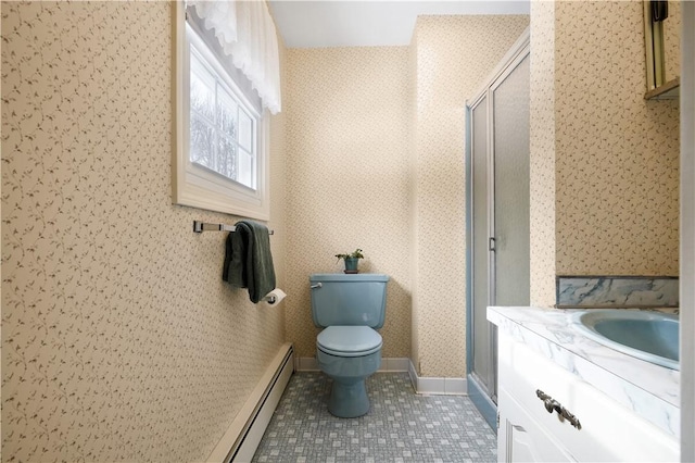 bathroom with sink, baseboard heating, a shower with shower door, tile patterned floors, and toilet