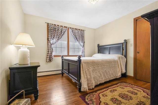 bedroom featuring a baseboard radiator and dark hardwood / wood-style floors