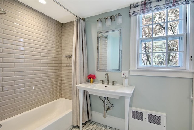 bathroom featuring sink, radiator heating unit, and shower / bath combo