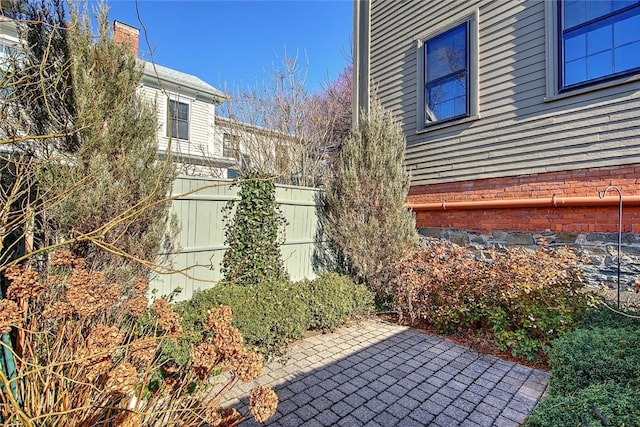 view of side of property with a patio