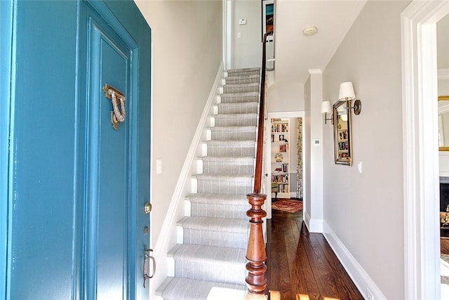 staircase featuring wood-type flooring