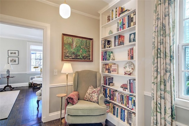 living area with ornamental molding and dark hardwood / wood-style floors