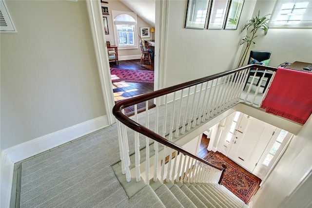 stairs featuring lofted ceiling