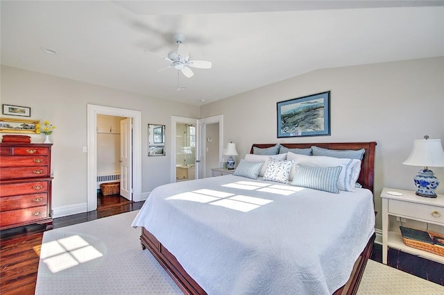 bedroom featuring lofted ceiling, dark hardwood / wood-style floors, ceiling fan, and ensuite bathroom