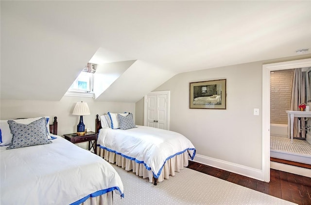 bedroom featuring lofted ceiling and dark hardwood / wood-style flooring