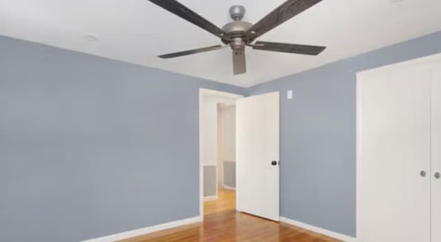 spare room with ceiling fan and hardwood / wood-style floors