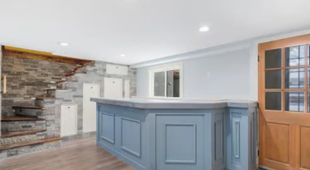 kitchen with blue cabinetry and light wood-type flooring