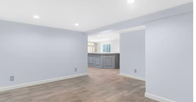 empty room with light hardwood / wood-style flooring