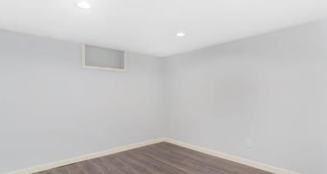 spare room featuring dark hardwood / wood-style floors