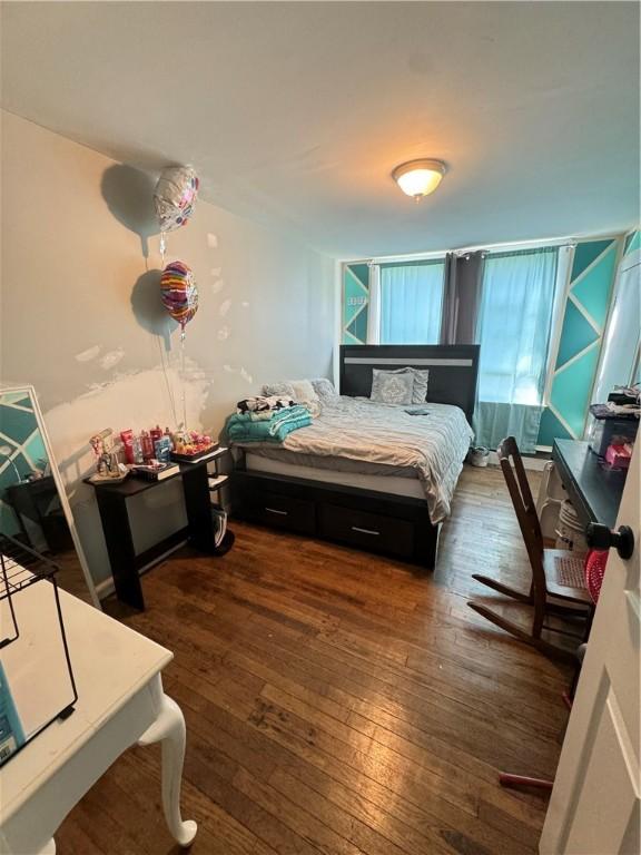 bedroom with dark wood-type flooring