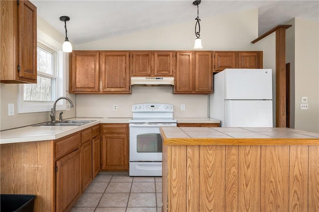 kitchen featuring lofted ceiling, sink, white appliances, light tile patterned floors, and hanging light fixtures