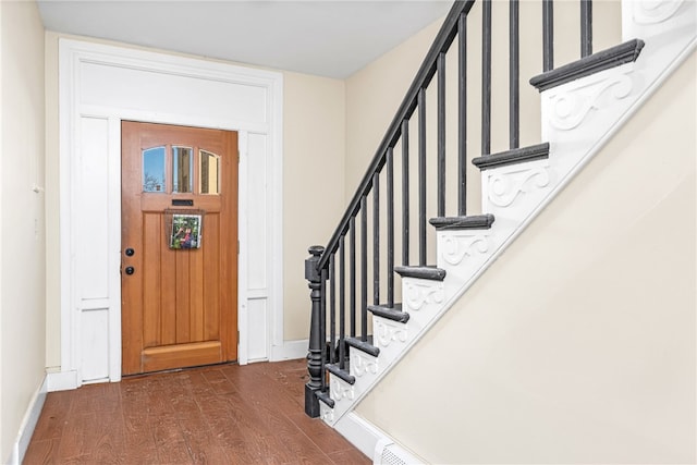 foyer entrance with dark hardwood / wood-style floors