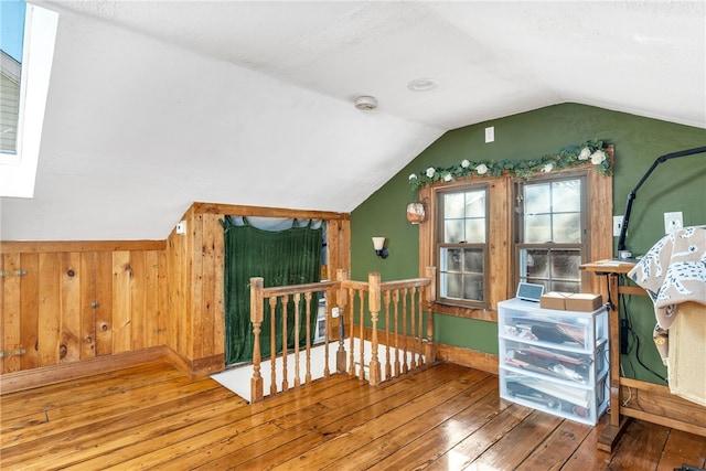 bonus room with wood-type flooring and lofted ceiling