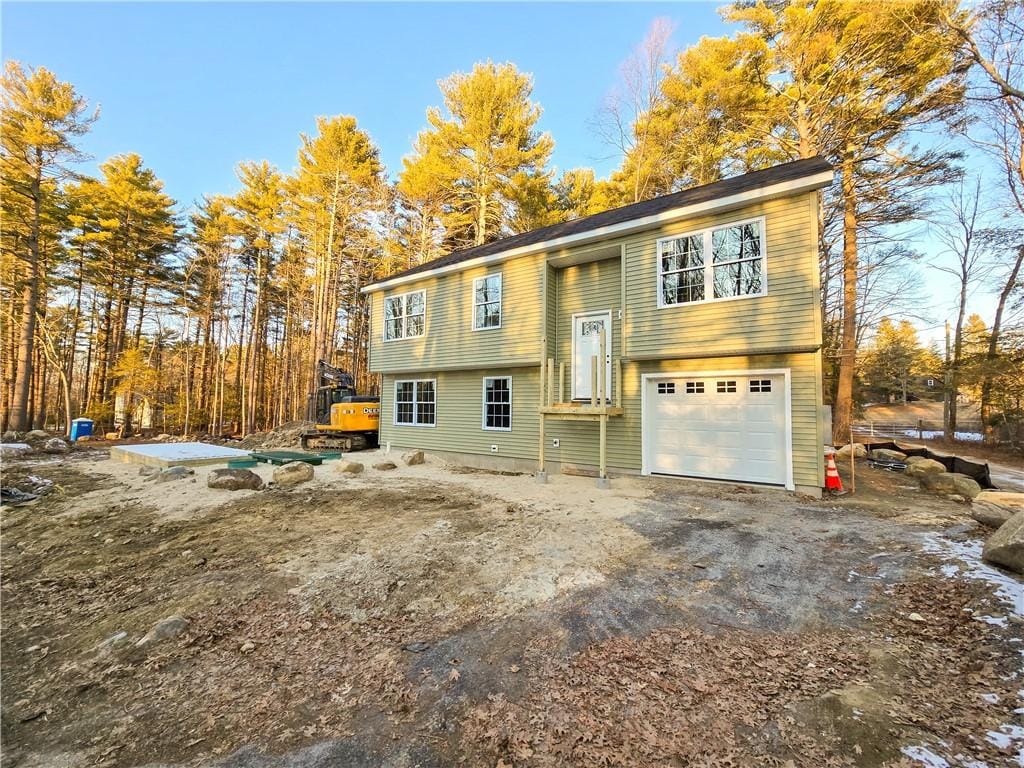 bi-level home with driveway and an attached garage