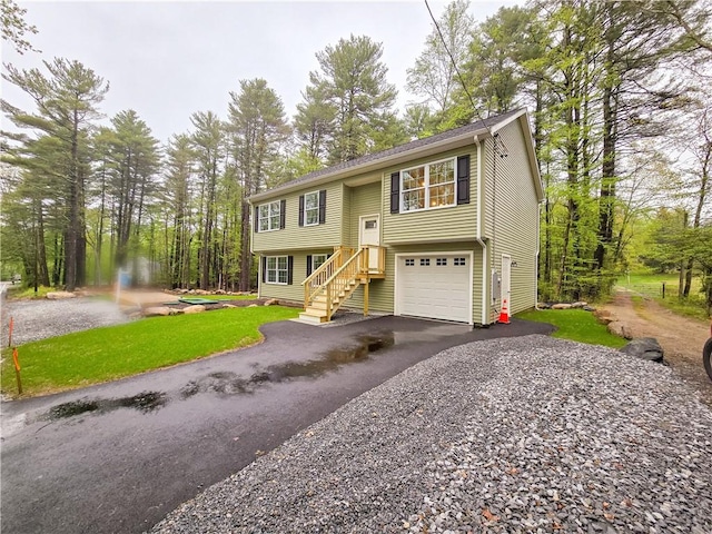 650 Reservoir Rd, Burrillville, RI 02859 - raised ranch featuring a front yard, aphalt driveway, and an attached garage