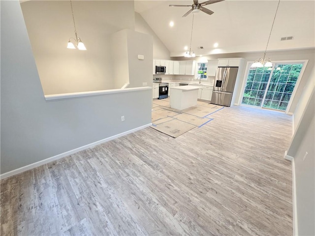 650 Reservoir Rd, Burrillville, RI 02859 - kitchen featuring stainless steel appliances, ceiling fan with notable chandelier, light wood finished floors, open floor plan, and baseboards