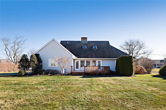 rear view of property with a wooden deck and a yard