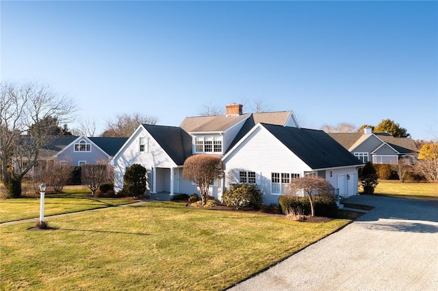 view of front of house with a garage and a front yard