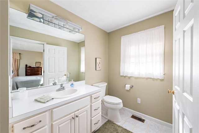 bathroom with vanity, tile patterned flooring, and toilet