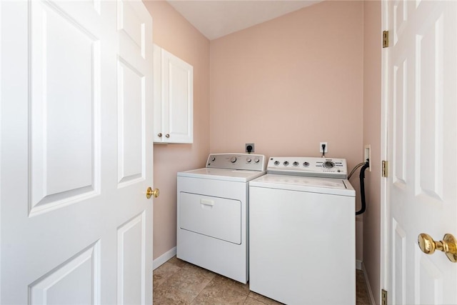 laundry room with washer and dryer and cabinets