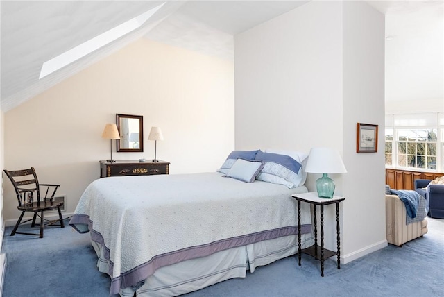 carpeted bedroom with lofted ceiling with skylight