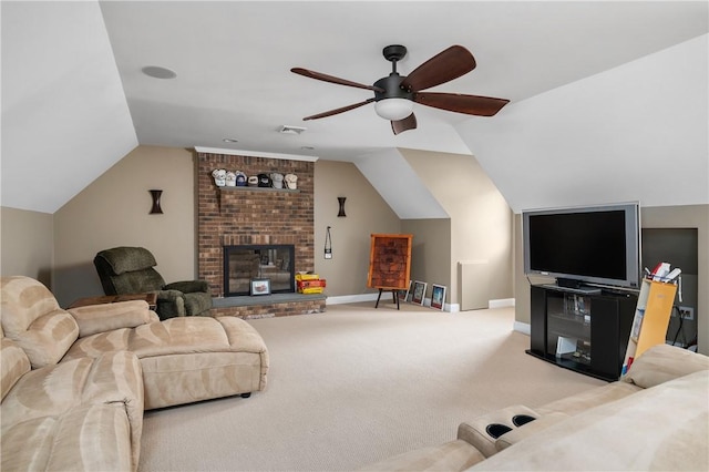 living room with vaulted ceiling, ceiling fan, a fireplace, and carpet floors