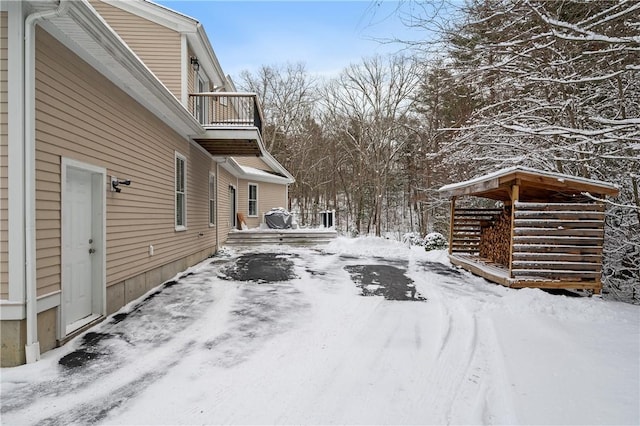 snowy yard with a balcony