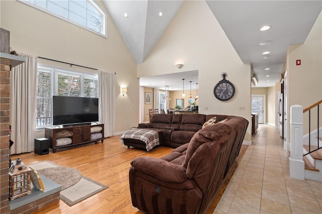 tiled living room featuring high vaulted ceiling