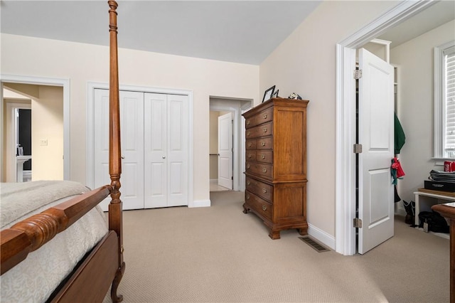 bedroom with a closet and light carpet