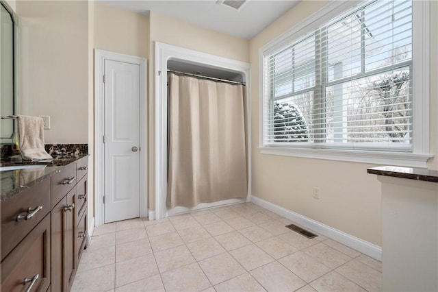 bathroom with tile patterned flooring and vanity