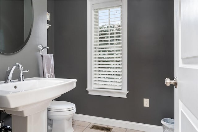 bathroom with tile patterned flooring, sink, and toilet