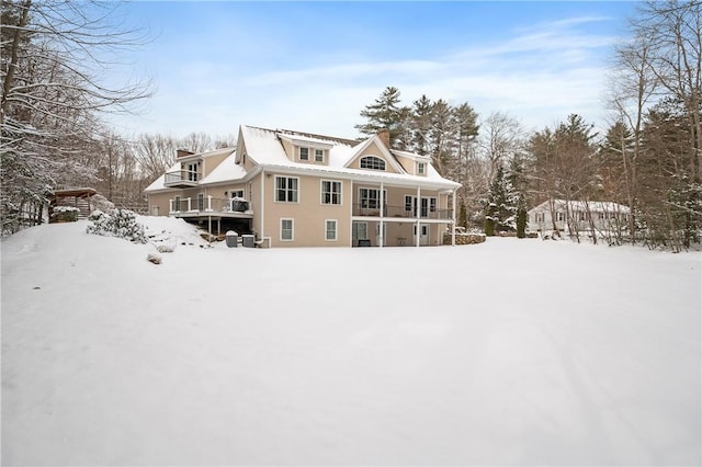 view of snow covered rear of property