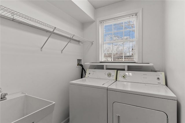 washroom with sink and washer and dryer