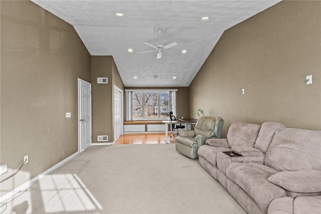 living room featuring vaulted ceiling, light carpet, and ceiling fan