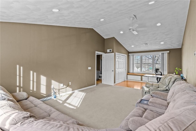 living room featuring lofted ceiling, light carpet, and ceiling fan