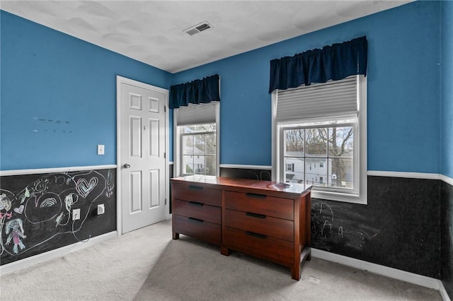 bedroom featuring light carpet