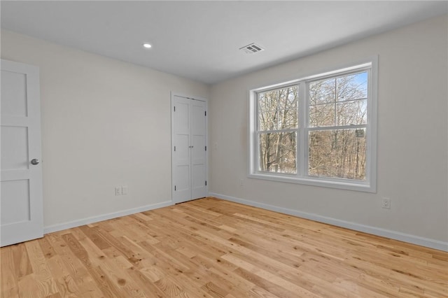 spare room featuring light hardwood / wood-style flooring