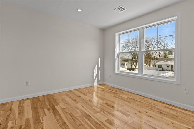 empty room with light hardwood / wood-style flooring