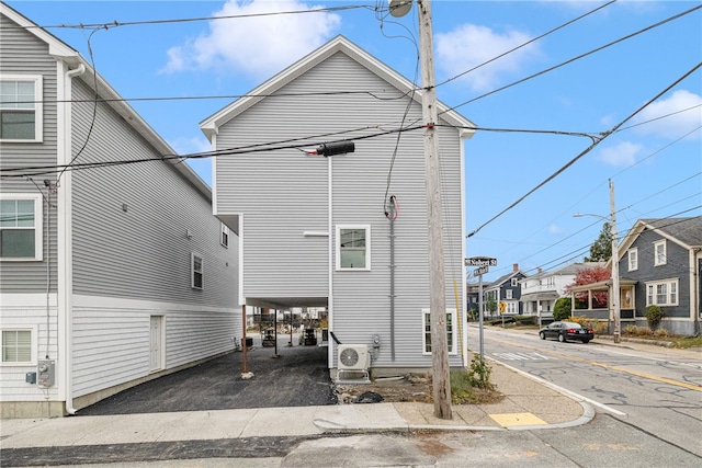 rear view of house featuring ac unit and a residential view