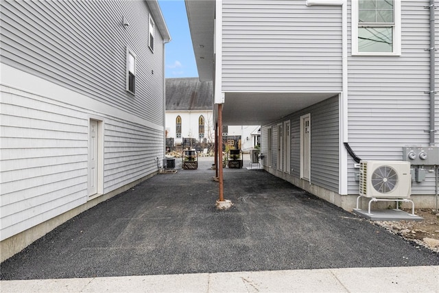 exterior space featuring a carport, ac unit, and cooling unit